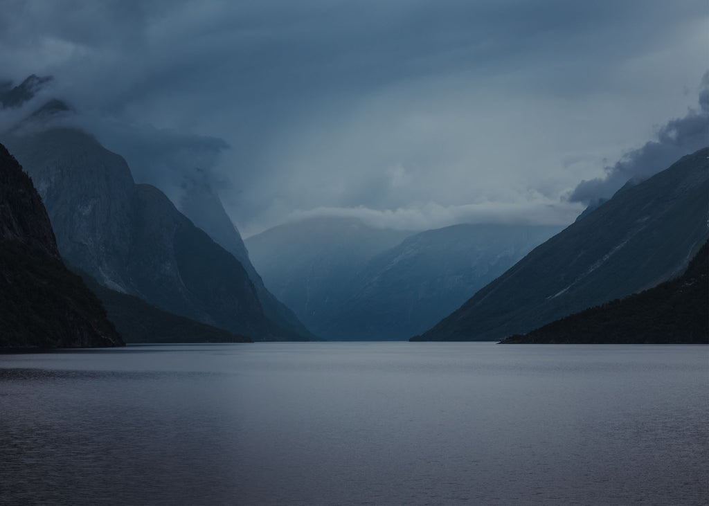 Blå dimmig fjord i Norge. Poster i olika storlekar: 30x40 cm, 40x50 cm, 50x70-cm, 70x100 cm.